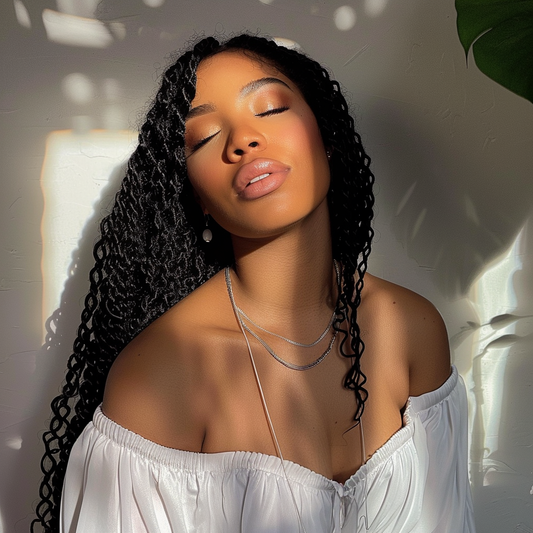 Black woman with curly twist box braids wearing a white top top
